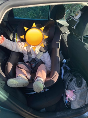 Kind winkt aus dem Graco Turn2Me Autositz